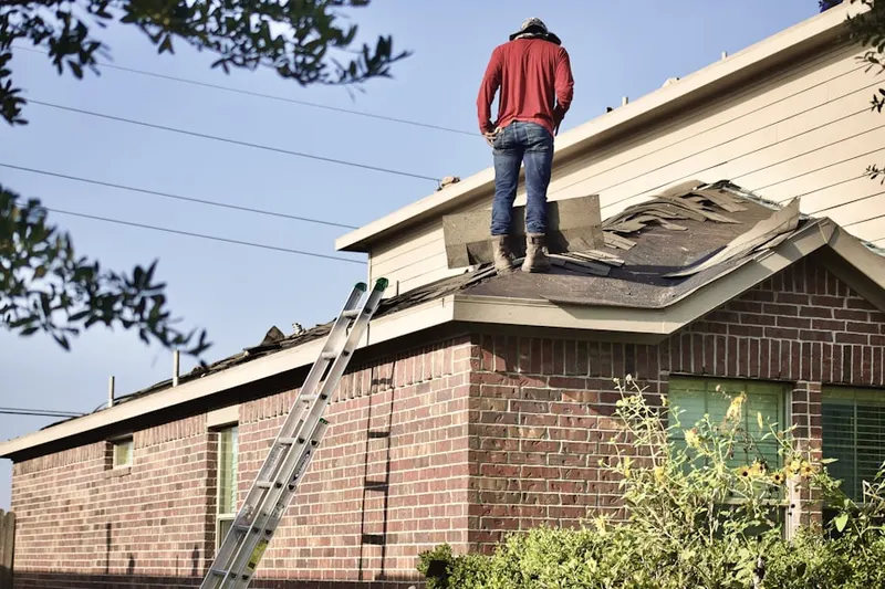 Professional roofer working on a residential roof in Krassdale